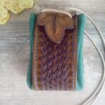 Skórzana sakiewka z motywem liścia.