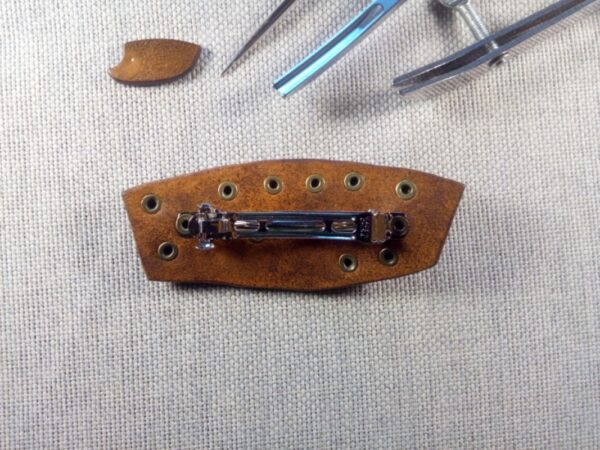 Tył skórzanej spinki do włosów - steampunk. Widok na metalową klamrę.